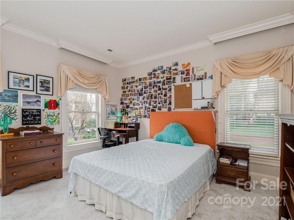 2131 Rolston Drive Charlotte, NC 28207 - Photo 29 of 35 a bedroom with a bed and furniture