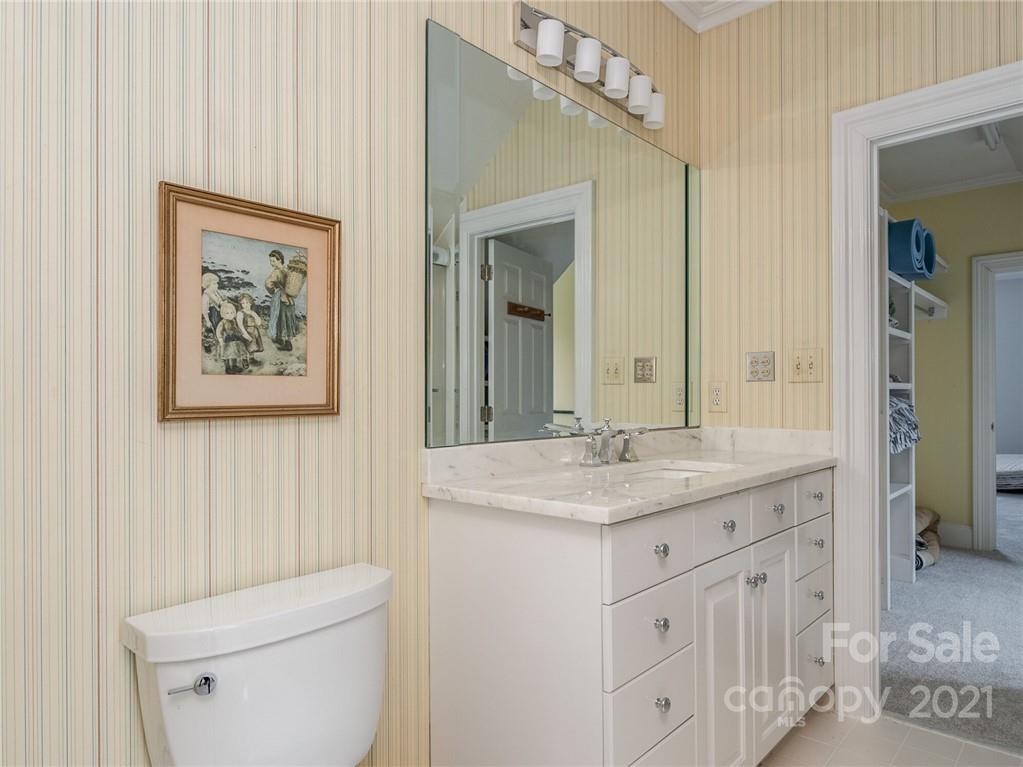 2131 Rolston Drive Charlotte, NC 28207 - Photo 32 of 35 a bathroom with a granite countertop sink a toilet and a mirror