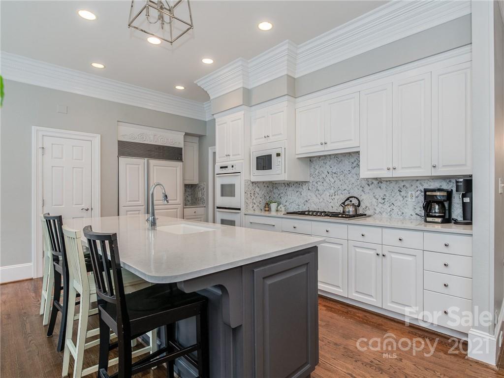 2131 Rolston Drive Charlotte, NC 28207 - Photo 10 of 35 a kitchen with stainless steel appliances granite countertop a table chairs sink and cabinets