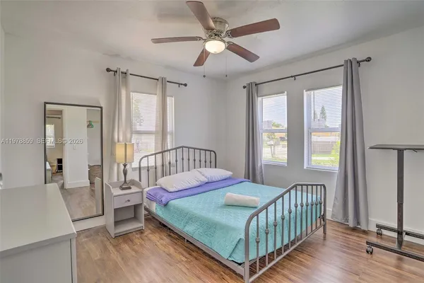 a bedroom with a bed and a window