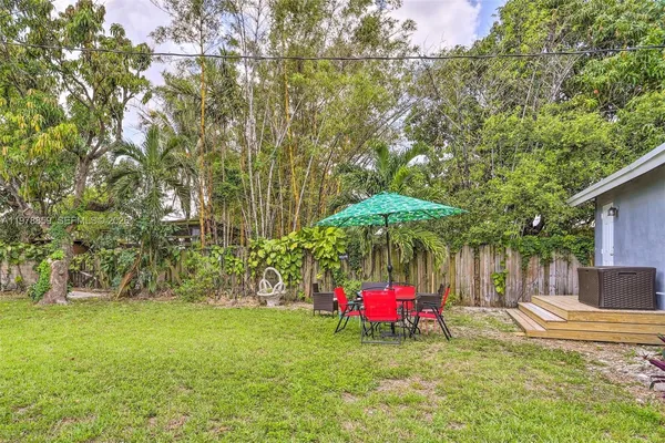 a view of a backyard with a tree
