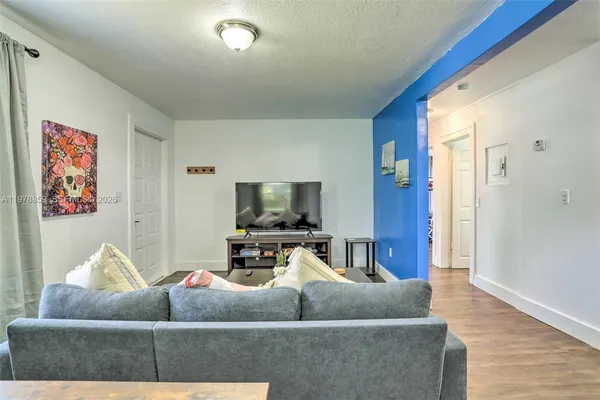 a living room with furniture and a flat screen tv
