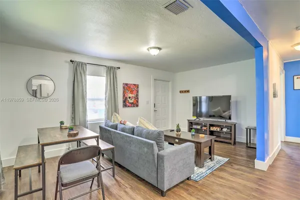 a living room with furniture and a flat screen tv