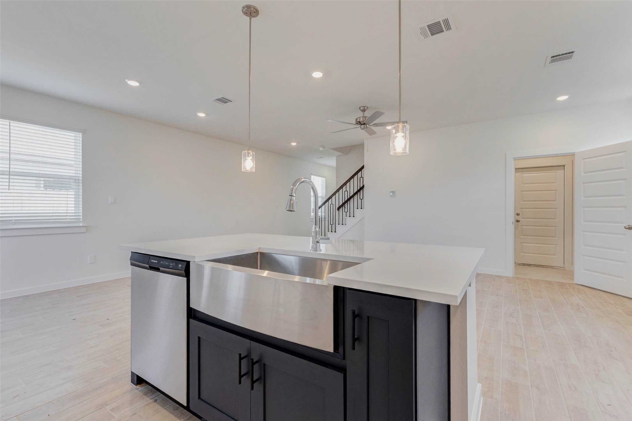 1131 Santee Court Rosharon, TX 77583 - Photo 11 of 31 Facing the staircase and living area, this angle highlights the fluid connectivity between spaces. Clean lines, soft neutral tones, and contemporary lighting create an airy, welcoming atmosphere ideal for hosting or relaxing.
