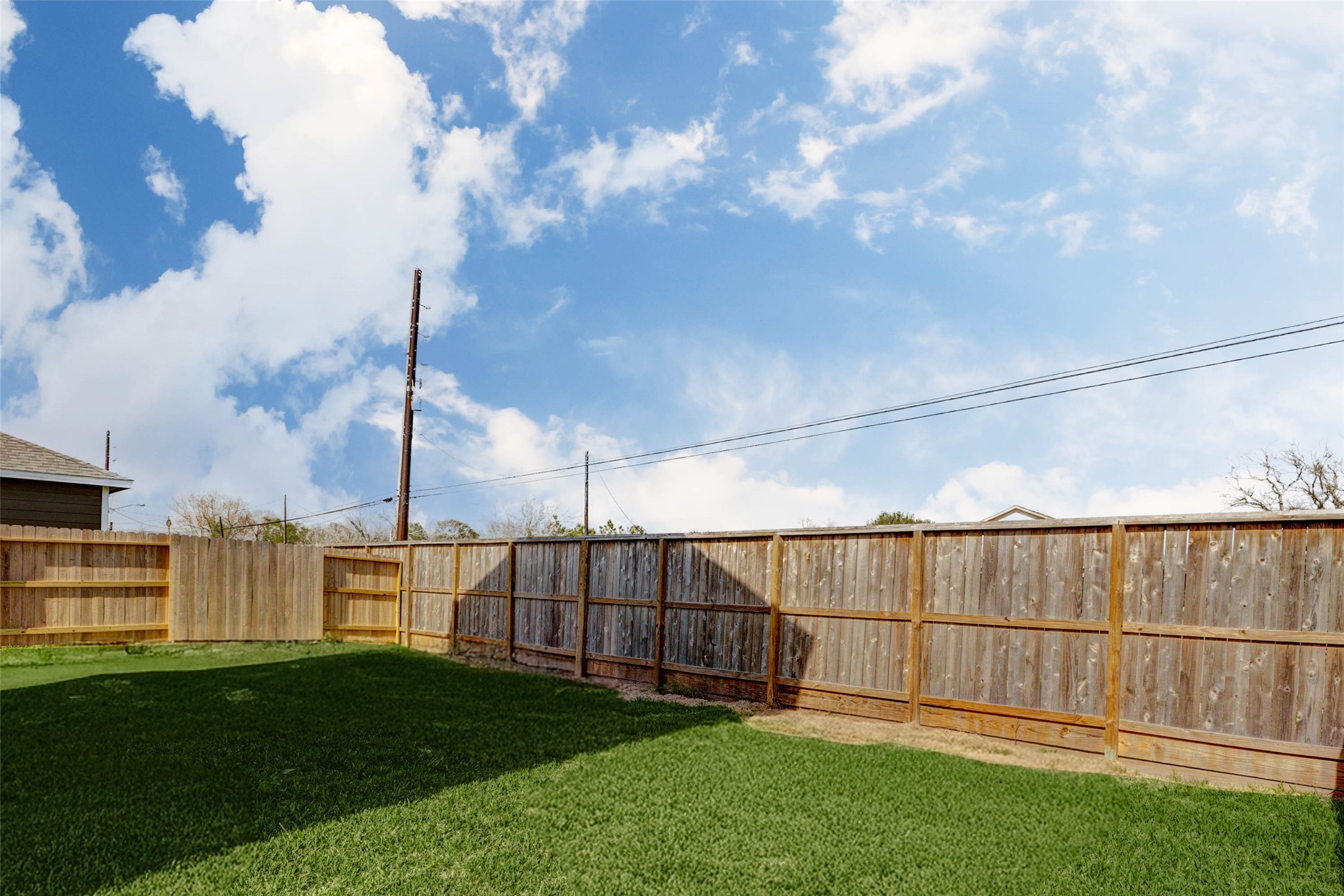 1131 Santee Court Rosharon, TX 77583 - Photo 28 of 31 Enjoy privacy and potential in this fully fenced backyard with a lush green lawn. Ideal for pets, kids, gardening, or future customization like a pergola or patio, this space offers both serenity and opportunity.