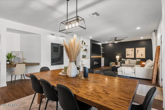 a kitchen with kitchen island granite countertop a sink cabinets and wooden floor
