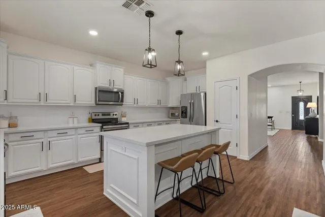 a living room with a flat screen tv and a bookshelf