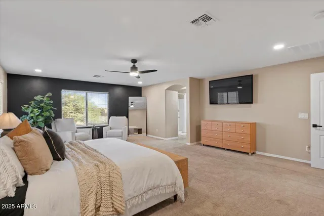 a living room with furniture and a ceiling fan