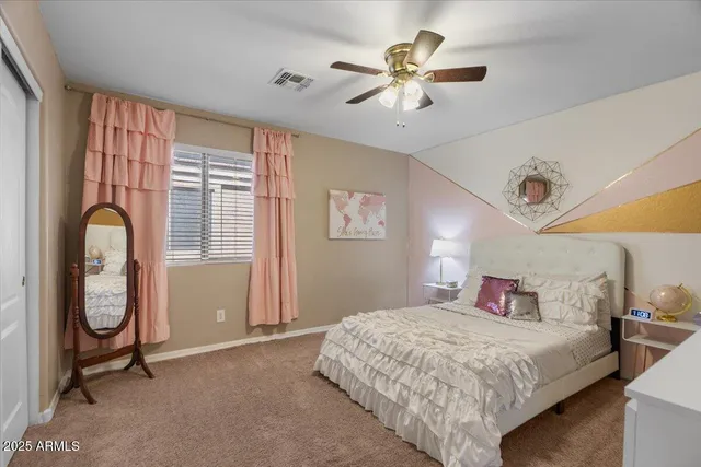 a bedroom with a bed and a potted plant