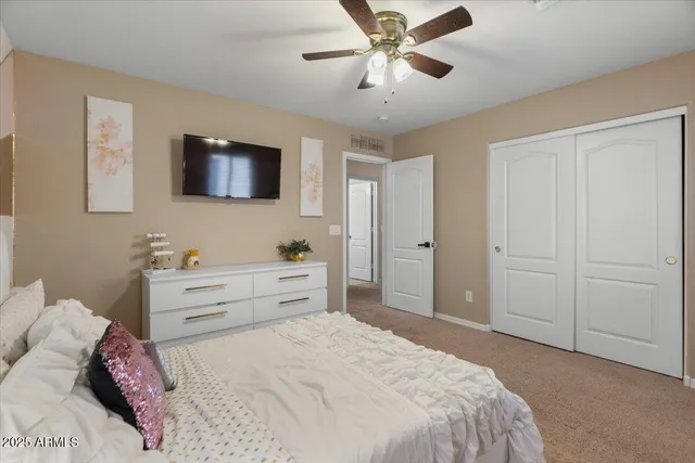 a bedroom with a bed and a potted plant