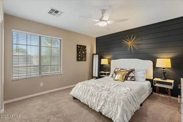 a bedroom with a bed and a window