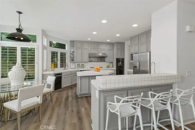 a kitchen with granite countertop white cabinets and stainless steel appliances