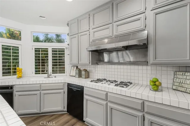 a kitchen with stainless steel appliances a sink stove and cabinets