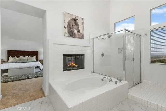 a bathroom with a tub sink and mirror