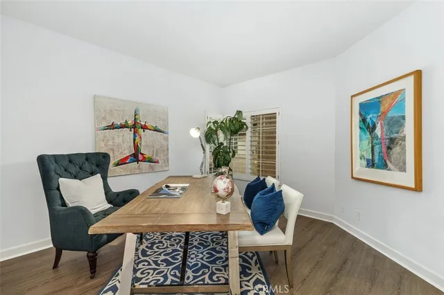 a living room with furniture and a painting on the wall