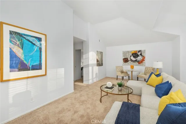 a bedroom with a bed and a lamp on dresser