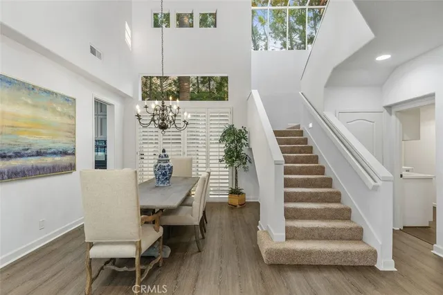 a view of a living room with furniture and wooden floor