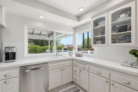 a kitchen with a sink and large window