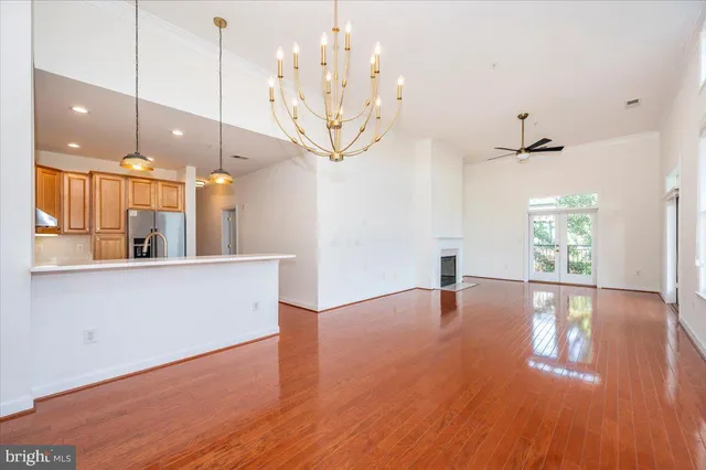 a view of a room with wooden floor and large windows