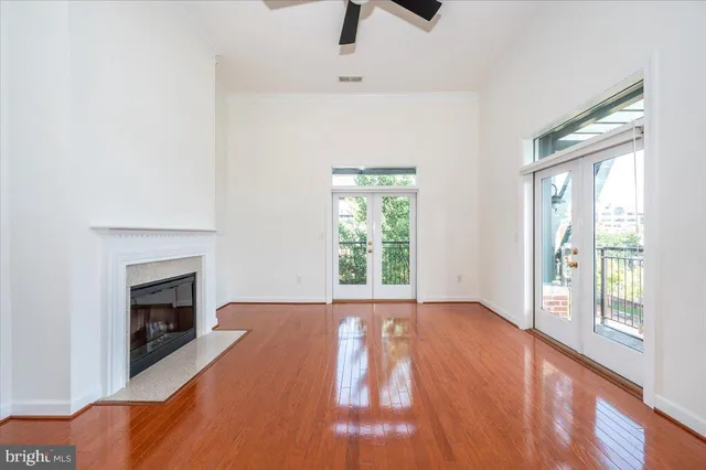 a view of an empty room with window and fire place