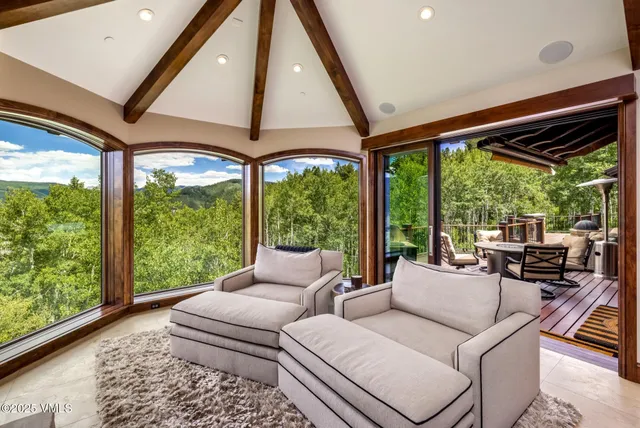 a very nice looking room with a large window and chairs