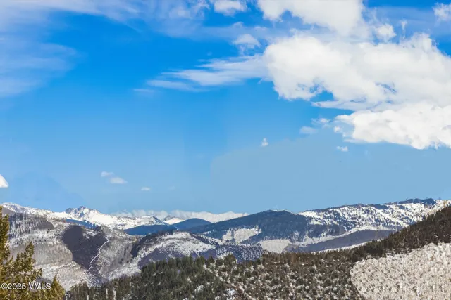 a bedroom with a large bed and a flat tv screen on dresser
