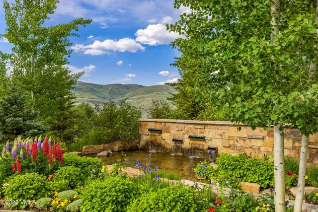 a view of a patio with table and chairs under an umbrella