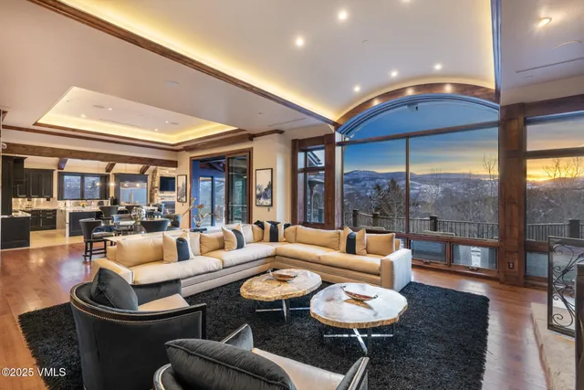 a living room with fireplace furniture and a large window