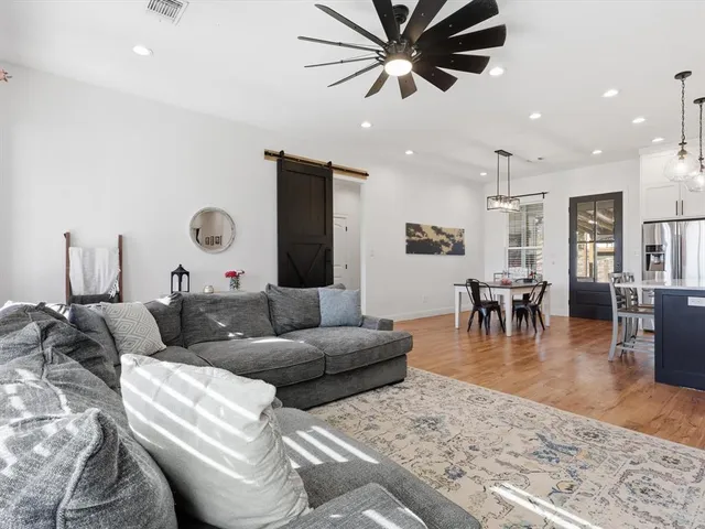 a view of a dining room with furniture wooden floor and chandelier