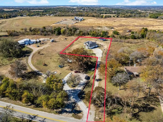 an aerial view of a residential houses with outdoor space