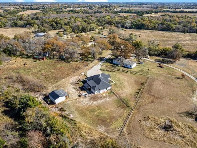 an aerial view of residential houses with outdoor space