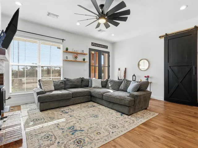 a living room with furniture and wooden floor