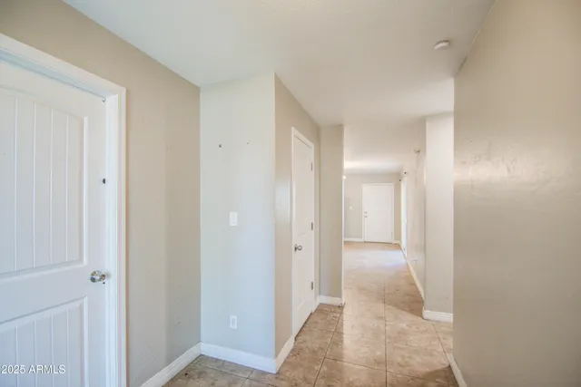 an empty room with a window and ceiling fan