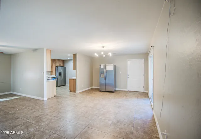 a view of an empty room with a ceiling fan