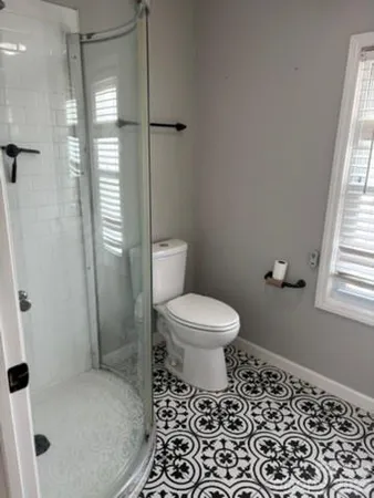 a bathroom with a toilet and a shower