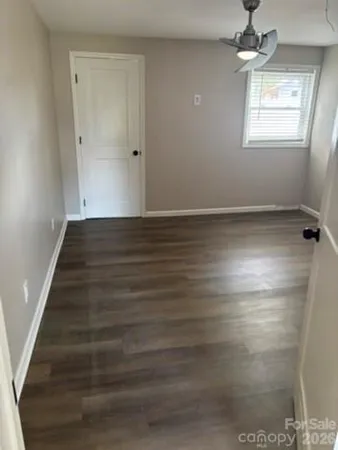 a view of a room with wooden floor and fan