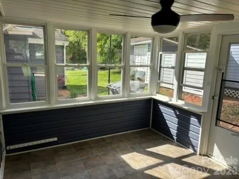 a room with a large window and a chandelier