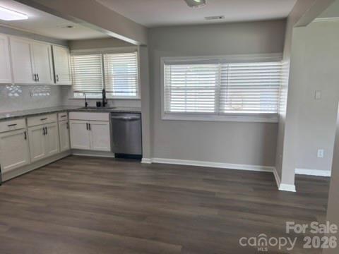 229 Browntown Road Belmont, NC 28012 - Photo 6 of 23 a kitchen with granite countertop a stove a sink and dishwasher wooden cabinets with wooden floor