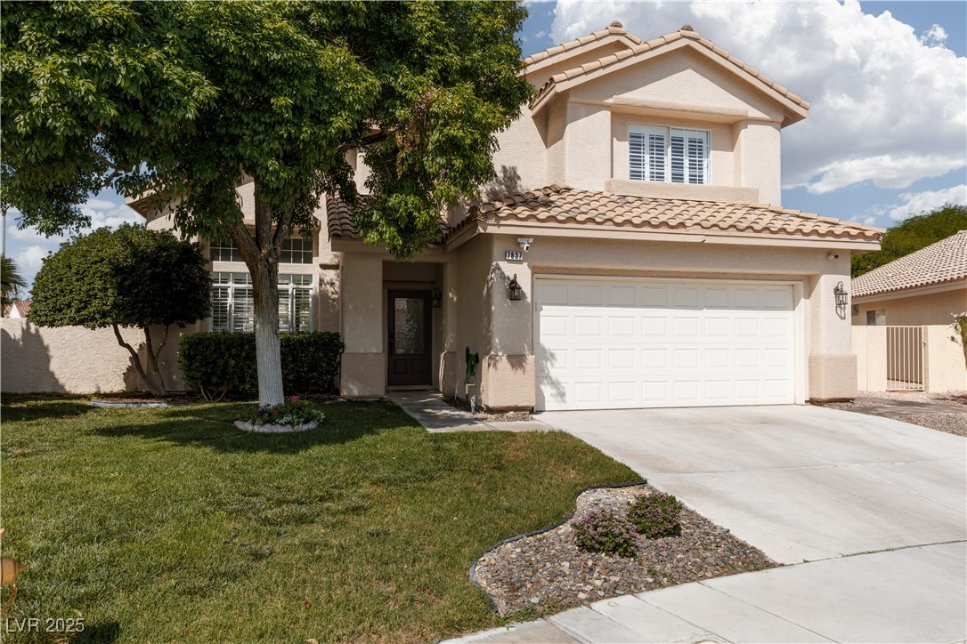 View of front of house featuring a tile roof, driveway, a garage, and stucco siding