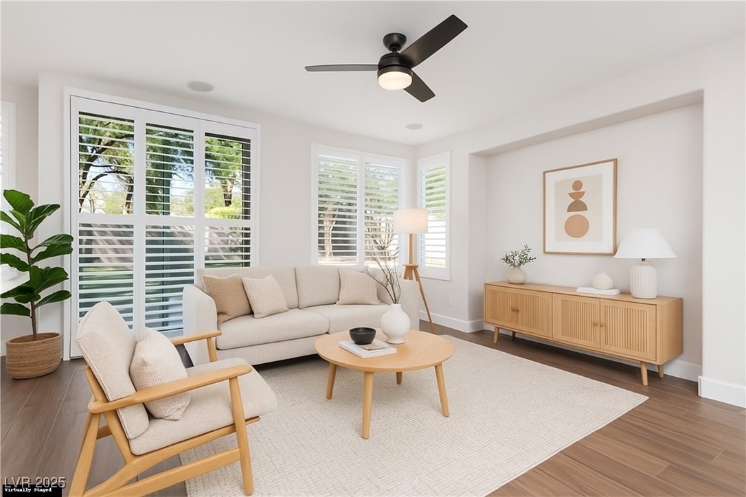 7837 Fort Ruby Place Las Vegas, NV 89128 - Photo 11 of 50 Virtually Staged Living area featuring dark wood finished floors and ceiling fan