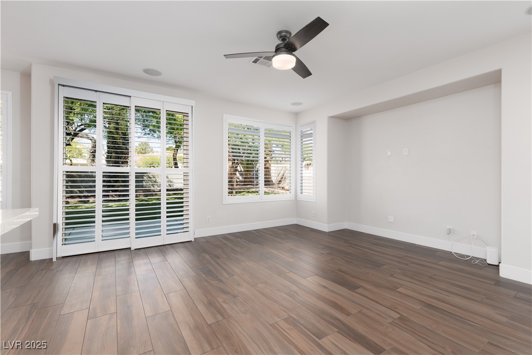 7837 Fort Ruby Place Las Vegas, NV 89128 - Photo 12 of 50 Unfurnished room featuring a ceiling fan, wood finished floors, and baseboards