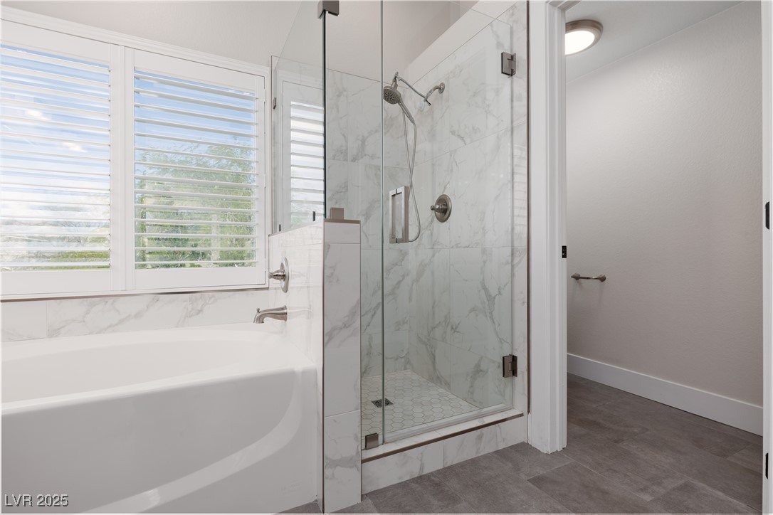 7837 Fort Ruby Place Las Vegas, NV 89128 - Photo 20 of 50 Bathroom featuring a bath, a marble finish shower, and baseboards