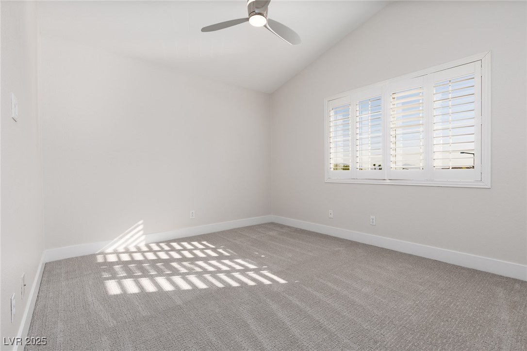 7837 Fort Ruby Place Las Vegas, NV 89128 - Photo 26 of 50 Carpeted empty room featuring lofted ceiling and ceiling fan