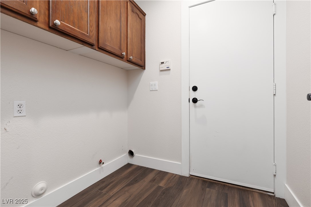 7837 Fort Ruby Place Las Vegas, NV 89128 - Photo 28 of 50 Washroom featuring hookup for a gas dryer, cabinet space, dark wood finished floors, and baseboards