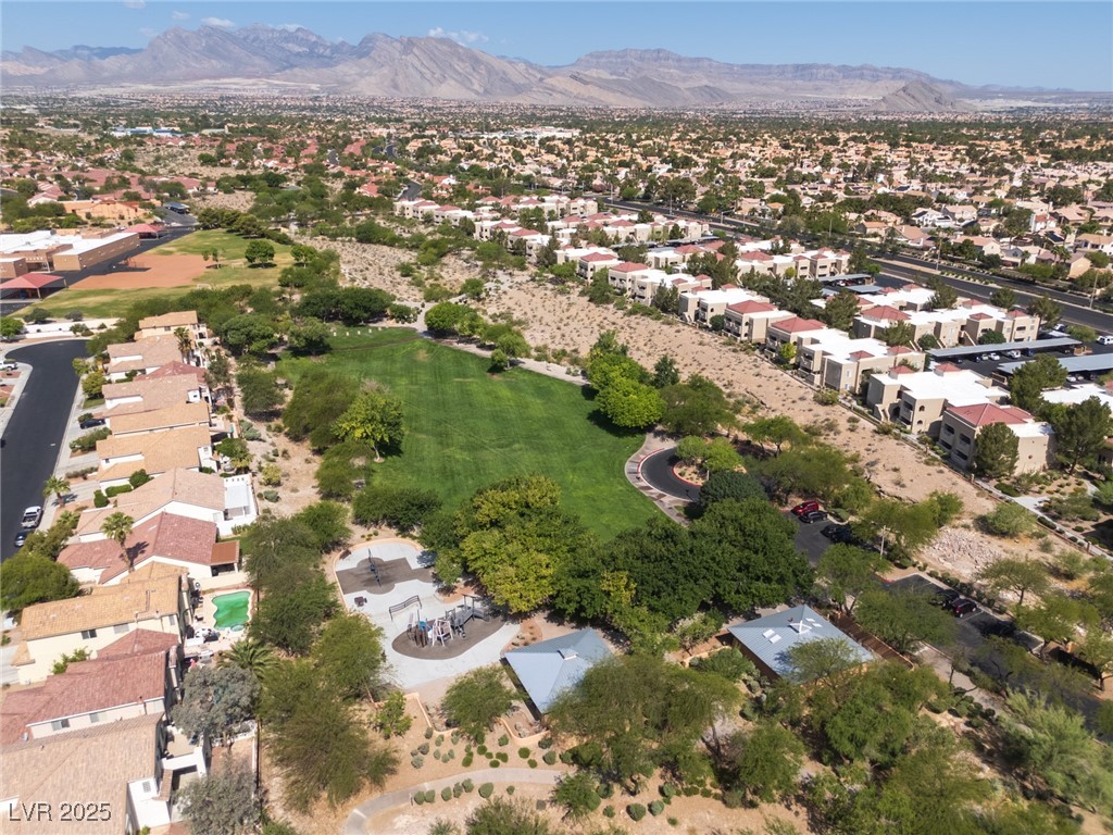 7837 Fort Ruby Place Las Vegas, NV 89128 - Photo 42 of 50 Aerial view of property and surrounding area with mountains and nearby suburban area