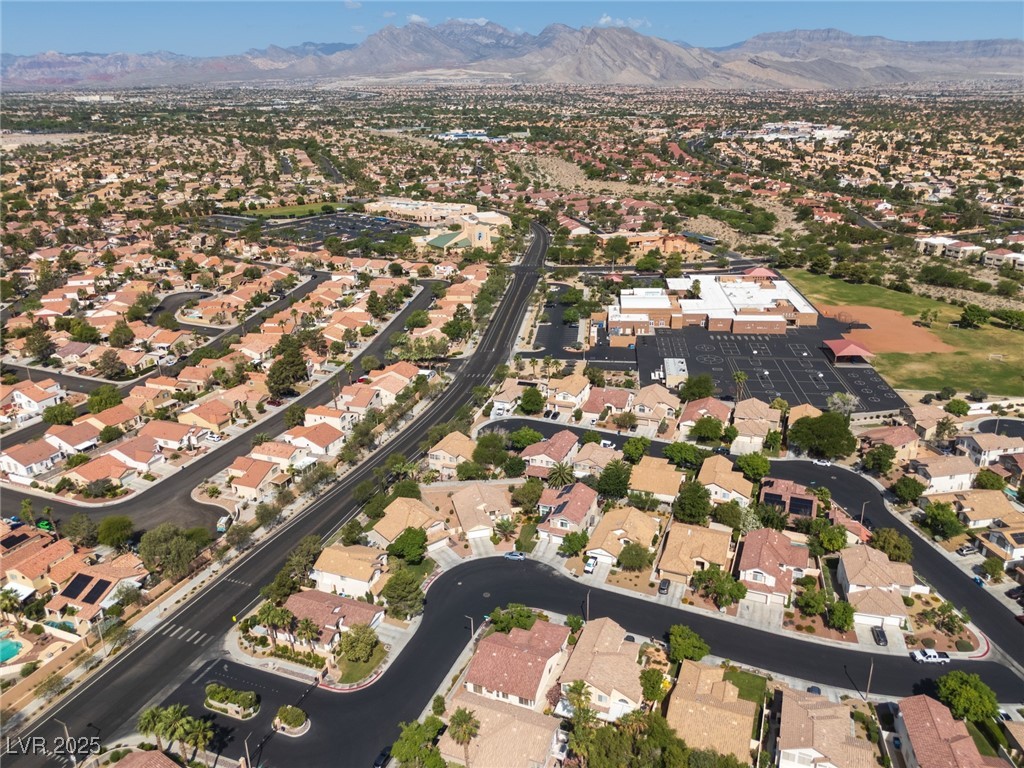 7837 Fort Ruby Place Las Vegas, NV 89128 - Photo 48 of 50 Aerial view of property and surrounding area featuring a mountainous background and nearby suburban area