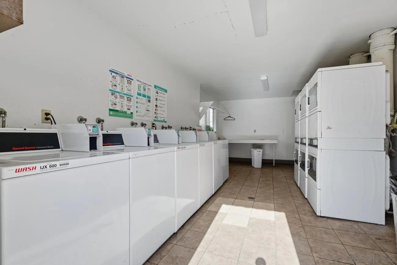 6775 Alvarado Road, Unit 10 San Diego, CA 92120 - Photo 21 of 22 a kitchen with a refrigerator and white cabinets