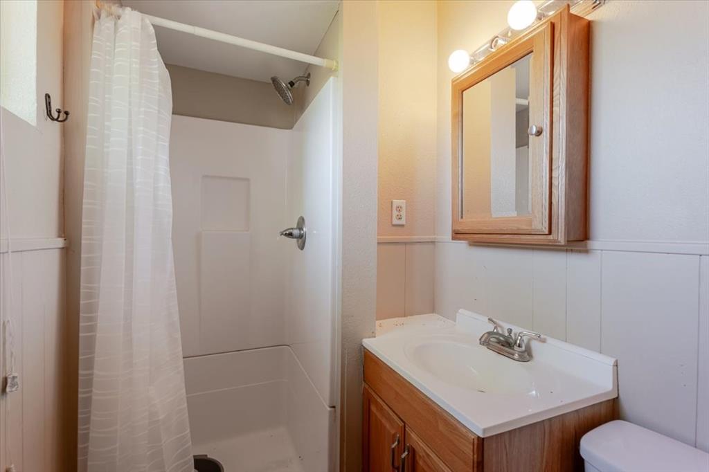 306 Grindstone Road Weatherford, TX 76087 - Photo 11 of 18 a bathroom with a sink toilet and vanity