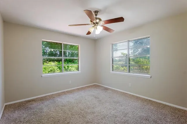 an empty room with windows and closet