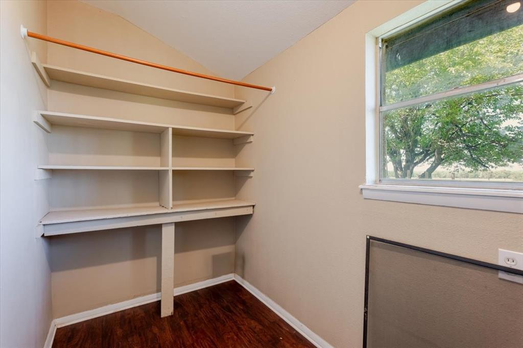 306 Grindstone Road Weatherford, TX 76087 - Photo 16 of 18 a view of a room with wooden floor and a window